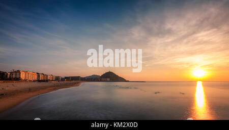 Coucher de soleil sur la plage de Zurriola par et mont Urgull à Donostia San Sebastian Banque D'Images