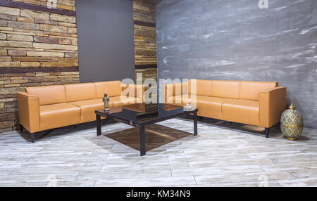 Vintage moderne ,intérieur salon canapé en cuir marron, blanc sur le parquet et mur de briques. Banque D'Images