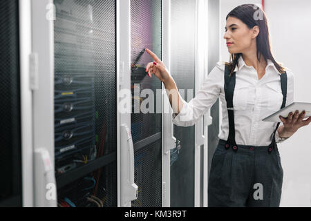 À l'aide d'un technicien lors de l'analyse de l'ordinateur tablette server en grand centre de données Banque D'Images