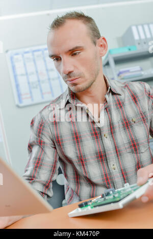 Man fixing computer Banque D'Images