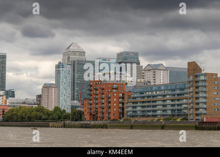 Les tours de Canary Wharf supervisent les appartements, les appartements et les maisons côté rivière le long des rives de la Tamise, Londres, Royaume-Uni Banque D'Images