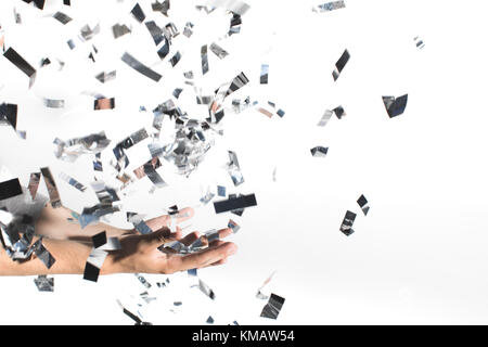 Woman catching falling confetti Banque D'Images