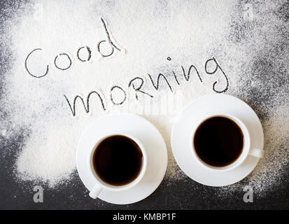 Bon matin inscription sur la carte avec la farine et deux tasses de café Banque D'Images