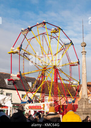 Carrousel rouge et jaune à l'extérieur de la roue avec les personnes ci-dessous ciel bleu de Noël ; Essex ; Angleterre ; uk Banque D'Images