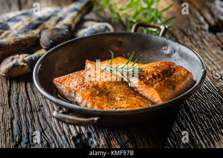 Le saumon. Deux darnes de saumon juteux en rôtissoire avec herb décoration sur table en chêne rustique. Banque D'Images