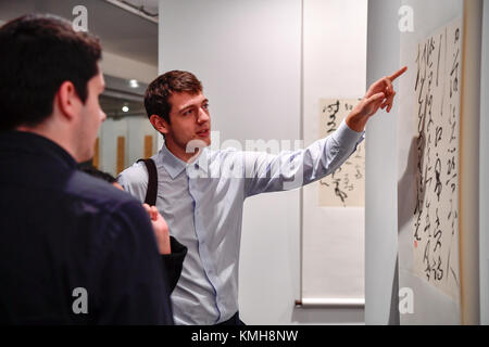 Paris, France. Dec 11, 2017. Les visiteurs d'admirer un morceau de calligraphie chinoise créé par Zhang Xuguang à l'Organisation des Nations Unies pour l'éducation, la science et la culture (UNESCO), siège à Paris, France, le 11 décembre, 2017. 'L'Aspirant à la paix--Zhang Xuguang Cursive de l'Exhibition' le coup d'ici lundi. Environ 50 pièces de calligraphie chinoise de Zhang Xuguang salue les visiteurs jusqu'au 16 décembre. Crédit : Chen Yichen/Xinhua/Alamy Live News Banque D'Images