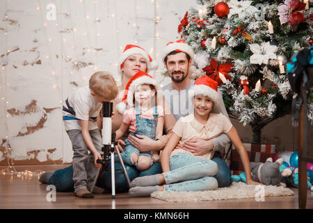 Nouvelle année, le droit des parents, deux filles et fils avec telescope Banque D'Images