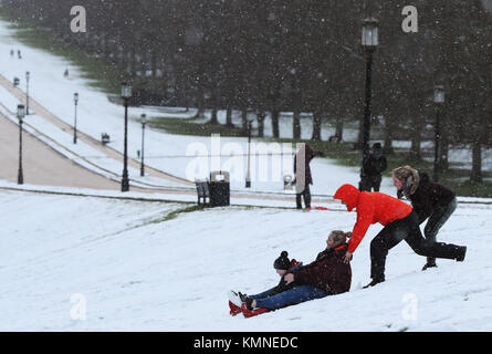 Les gens vont en luge au motif de Stormont Estate, Belfast, en tant que parties du Royaume-Uni et l'Irlande s'est réveillé d'une couche de neige causé par un flux d'air arctique dans le sillage de la tempête Caroline. Photo date : vendredi 8 décembre 2017. Histoire voir l'activité de Caroline météo. Crédit photo doit se lire : Brian Lawless/PA Wire Banque D'Images