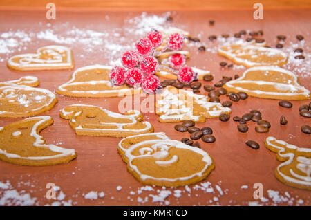 Pains de Noël avec glaçage blanc, les grains de café et Rowan twig pour décoration sur une planche en bois Banque D'Images