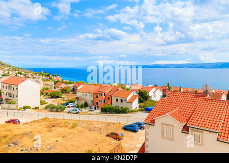 Vue d'orange, toits de maisons de la ville de Bol et mer en arrière-plan, l'île de Brac, Croatie Banque D'Images