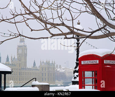 Palais de Westminster couvert de neige, avec l'emblématique téléphone rouge britannique sur la rive sud, scène d'hiver de Londres, Angleterre, Royaume-Uni Banque D'Images