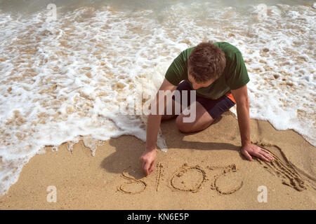 Un homme sur la plage est la peinture sur le sable en 2018. Banque D'Images