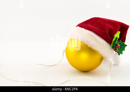 Boule de Noël avec Santa's hat et écouteurs, isolé sur blanc avec copy-space Banque D'Images