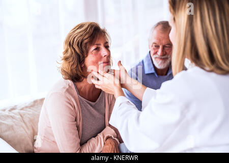 Female doctor examining a senior woman. Banque D'Images