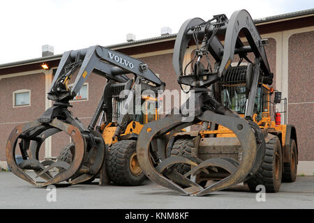 KYRO, FINLANDE - le 20 juin 2014 : Deux Volvo L180F pelles chargeuses avec taille industrielle grappins. Le showels chargement sont conçus pour se connecter à la manipulation des grumes Banque D'Images