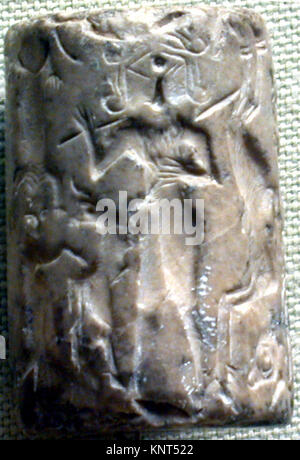 Un sceau cylindrique et une impression moderne de la collection MET montrant un taureau, un héros barbu et un concours de lion, démontrant des motifs artistiques mésopotamiens anciens. Banque D'Images