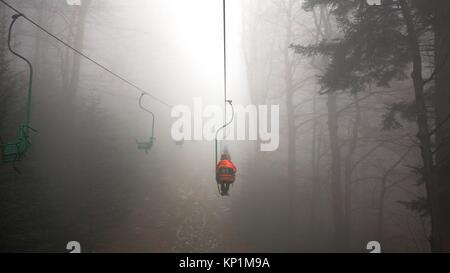 Les gens sur la montagne ascenseur par temps brumeux Banque D'Images