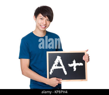 L'homme asiatique avec le tableau montrant d'un signe plus Banque D'Images