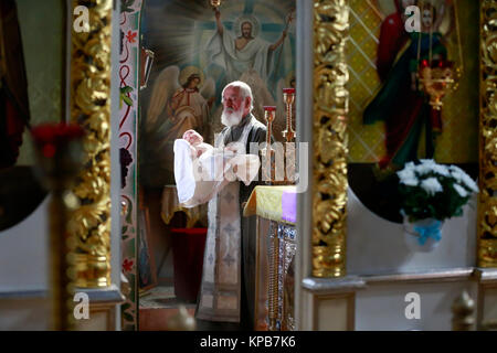 Le Bélarus, la ville de Gomel, le Monastère Saint Nicolas,10.09.2016.Le rite de baptême orthodoxe. Le prêtre porte le bébé Banque D'Images