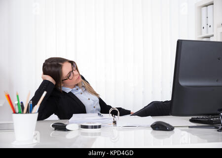 Two Businesswomen Leaning On Desk Banque D'Images