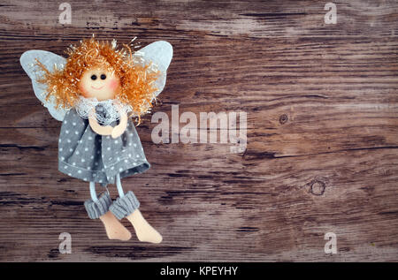 Vintage toy angel figurine on wooden table Banque D'Images