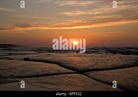 NC01071-00...CAROLINE DU NORD - L'en-comng tide comme le soleil se lève sur l'océan Atlantique à partir de la plage en face de l'Ocracoke Pony Pen, accueil du banquier Banque D'Images