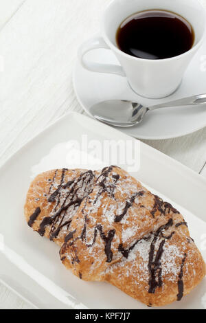 Pains au chocolat sur la plaque avec tasse de café Banque D'Images