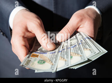 Man's hands holding dollars Banque D'Images