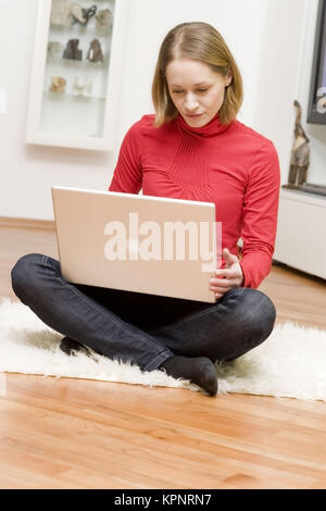 Modèle libération , Junge Frau sitzt mit Laptop in 1-2 - young woman with laptop Banque D'Images