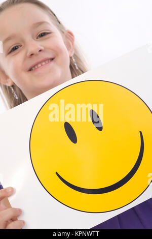 Modèle libération , Maedchen, 6 Jahre, mit lachendem Smileygesicht - fille avec smiley Banque D'Images