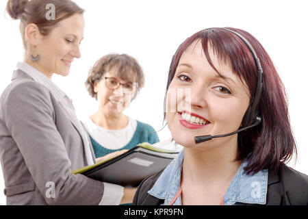 Close-up portrait of smiling young woman with headset Banque D'Images