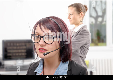 Close-up portrait of smiling young woman with headset Banque D'Images