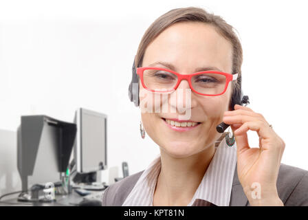 Close-up portrait of smiling young woman with headset Banque D'Images