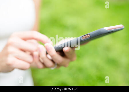 Femme utilisation de téléphone sur fond vert Banque D'Images