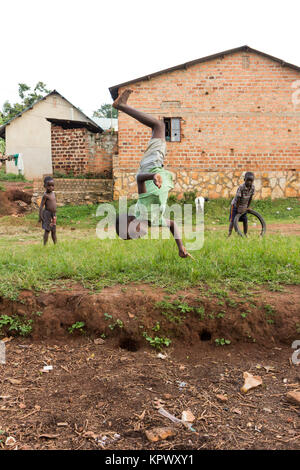 Lugazi, en Ouganda. 18 juin 2017. Un garçon ougandais faisant une bascule dans l'air. Banque D'Images