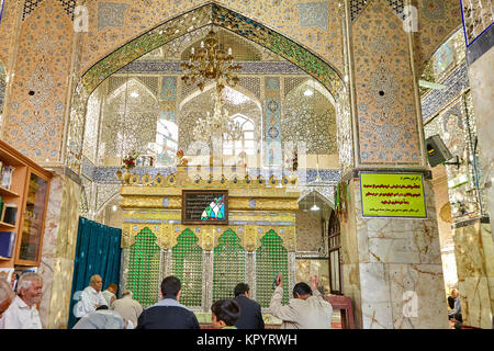 Yazd, Iran - avril 21, 2017 : culte de l'Fazel, les hommes assis sur un tapis et prier en salle de prière d'Sahhzade Fazel Lieu Saint. Banque D'Images