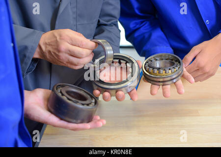 Tenue des roulements dans les mains de trois personnes Banque D'Images