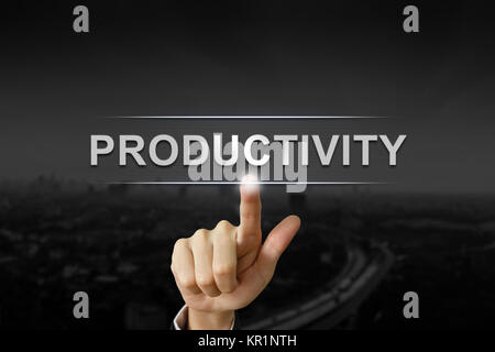 La productivité d'affaires part en poussant sur le bouton Arrière-plan flou noir Banque D'Images