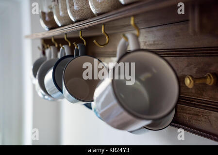 Tasses en cuisine sur mur en bois Banque D'Images