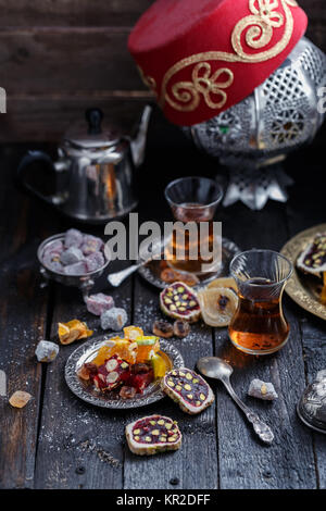 Thé turc traditionnel avec des bonbons orientaux traditionnels, fond sombre Banque D'Images