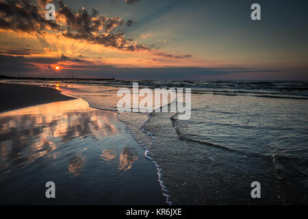 Coucher du soleil sur la plage avec un brise-lames en bois dans la mer baltique,leba, Pologne Banque D'Images