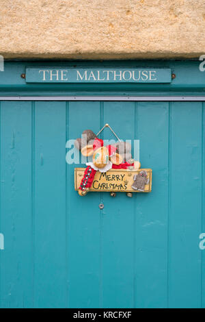 Décoration de Noël sur un chalet porte avant dans Snowshill village en décembre. Snowshill, Cotswolds, Gloucestershire, Angleterre Banque D'Images