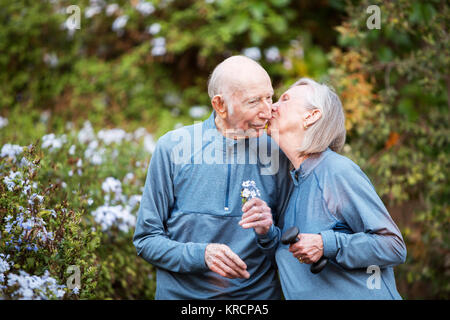 Loving couple kissing in garden Banque D'Images