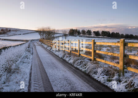 Une glaciale country lane à Rowarth Retour dans le Derbyshire, Angleterre dans un froid matin d'hiver. Banque D'Images