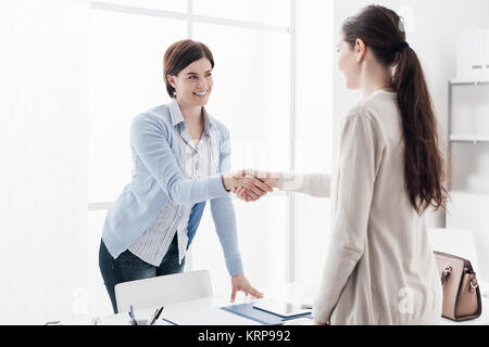 Réunion d'affaires dans le bureau, une femme est en lui donnant une poignée de main à la client ; entrevue d'emploi et de l'accord notion Banque D'Images