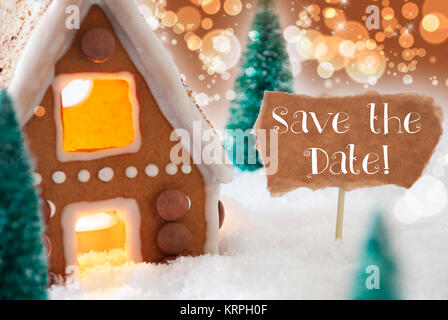 Texte anglais Réservez la date. Gingerbread House dans un paysage enneigé comme décoration de Noël. Les arbres de Noël et des bougies. Bronze et fond orange avec effet de flou. Banque D'Images