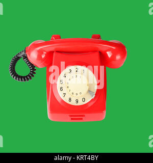 Beau téléphone vintage rouge sur fond vert. Banque D'Images