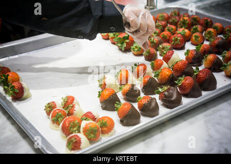 Un travailleur prépare des fraises au chocolat dans une boutique de chocolats Godiva dimanche à New York, le 17 décembre 2017. (© Richard B. Levine) Banque D'Images