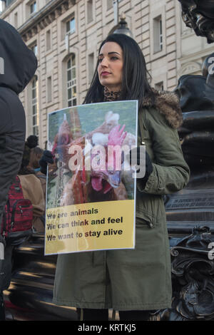 Une femme est titulaire d'un végétalien affiche montrant les poulets avec le message 'nous suis animal - nous pouvons penser et ressentir - nous voulons rester en vie" à la base de l'Éros à Piccadilly Circus Banque D'Images