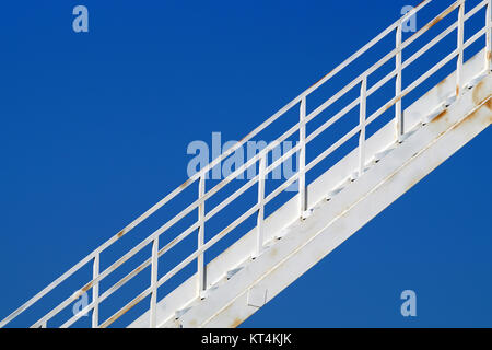 Un escalier jette une lourde sur un vieux réservoir de stockage d'argent. Escaliers cast ombres intéressantes en fin d'après-midi du soleil. L'argent. Métallique. Banque D'Images